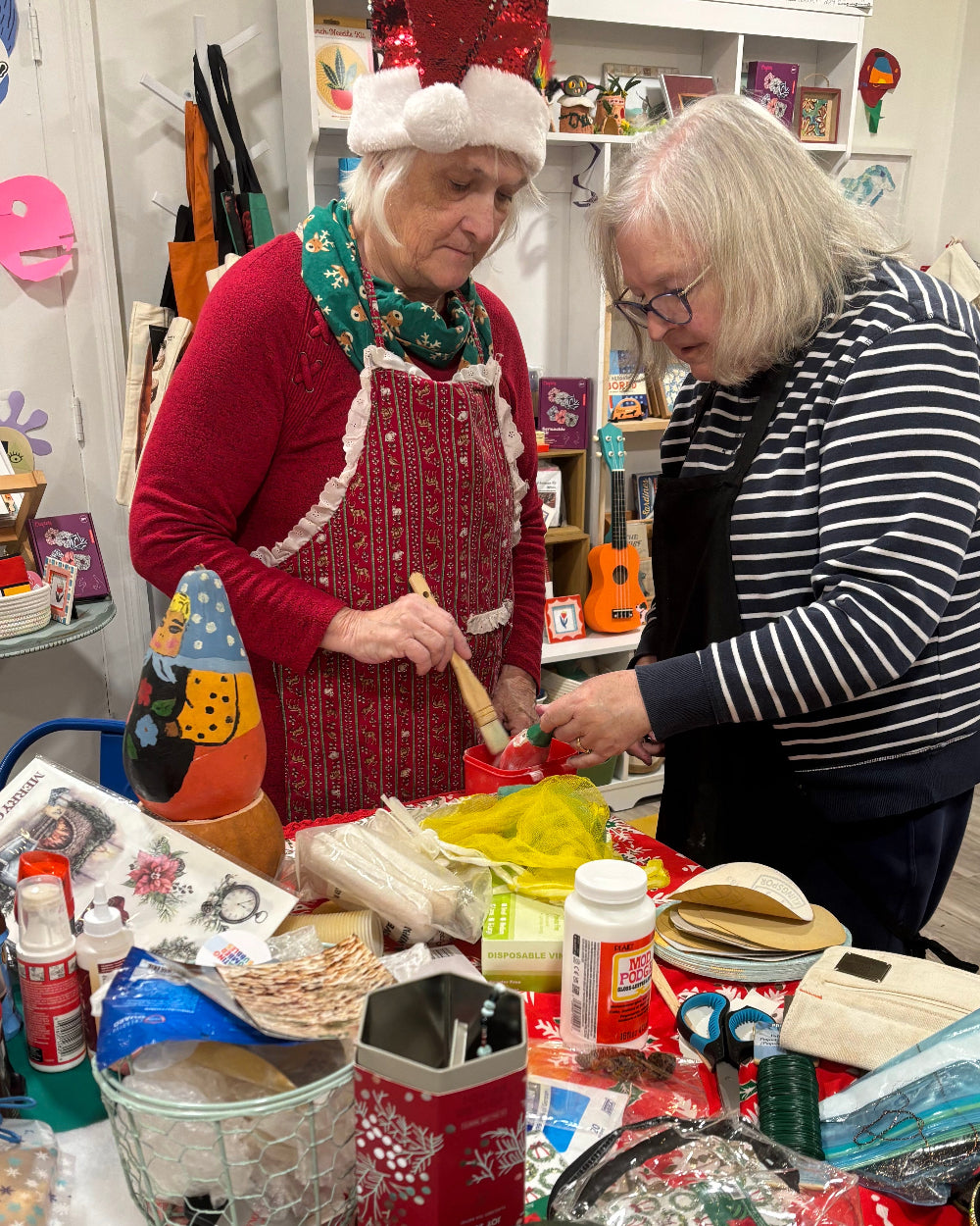 An instructor teaches gourd painting at All Good Art Studio